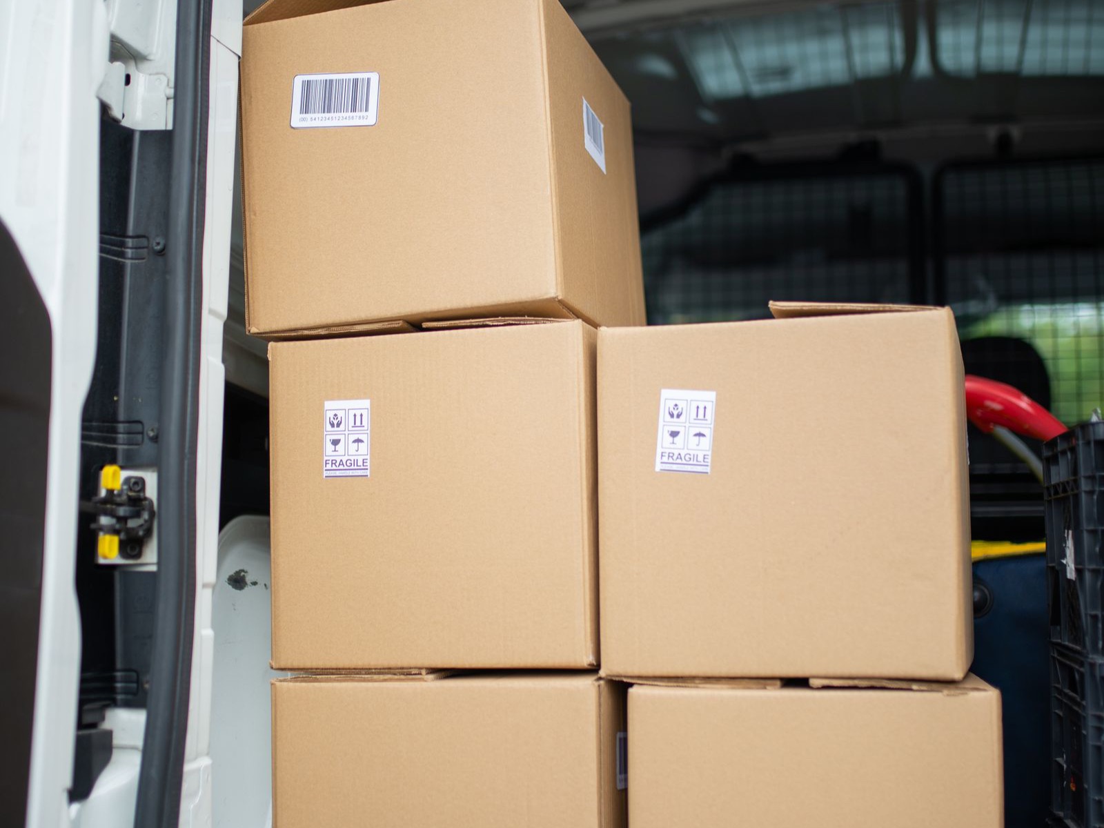 Labeled cardboard boxes loaded in a delivery van ready for shipment